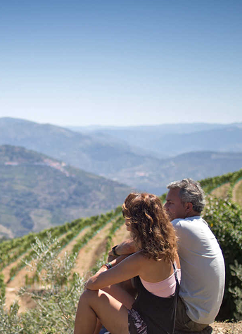 Couple enjoying panoramic views of Douro Valley vineyards